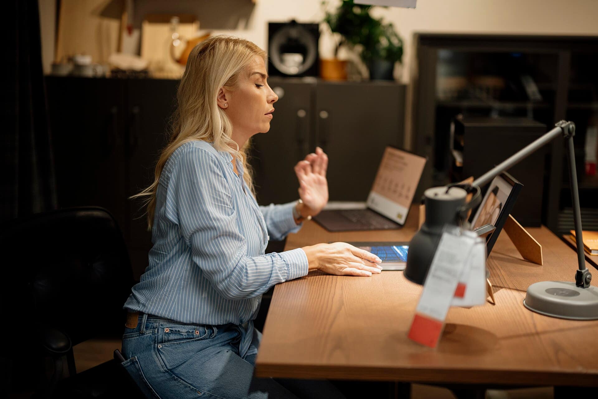 A business owner working on her laptop at a tidy desk.